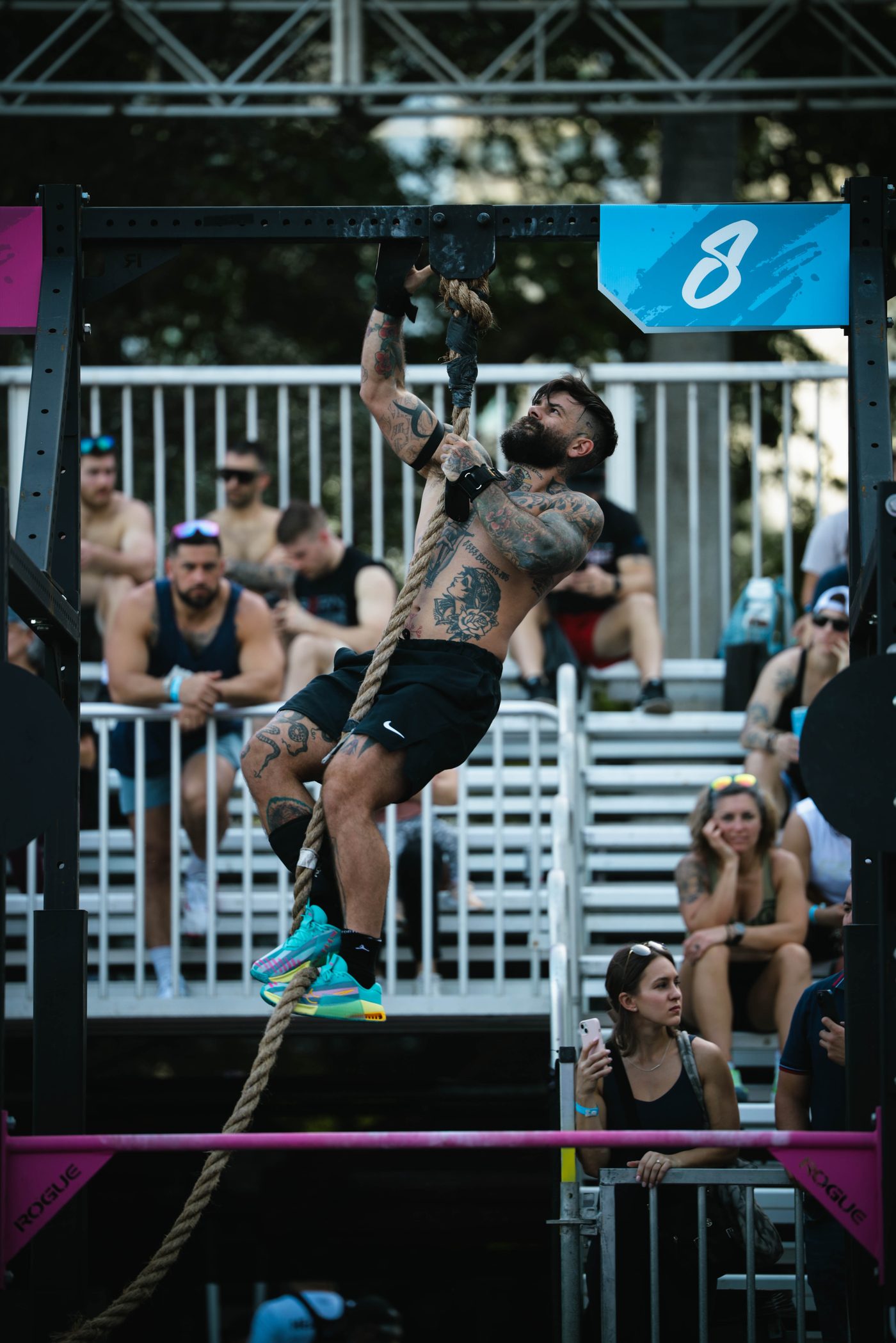 Scott Britton climbing a rope at a CrossFit competition