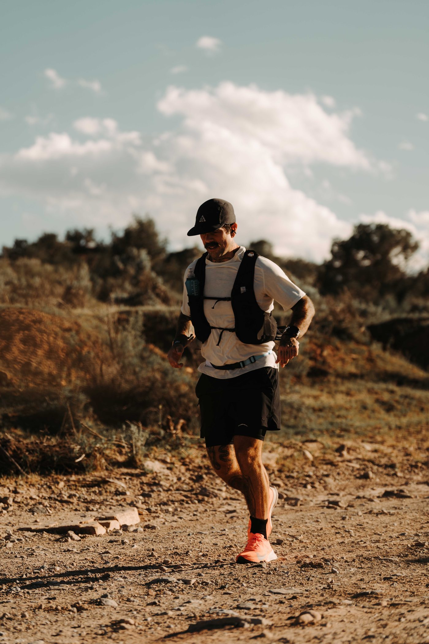 Scott Britton running a mountain trail in a hydration vest